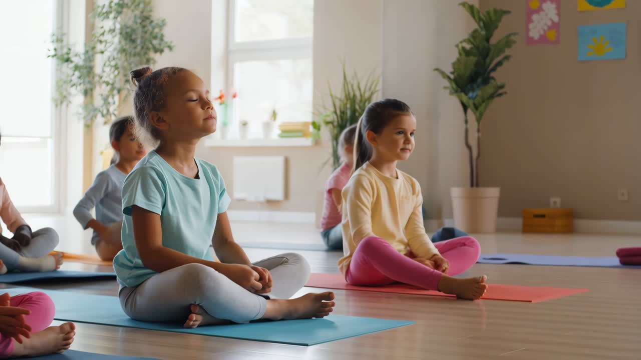 Children doing yoga and meditation in a classroom