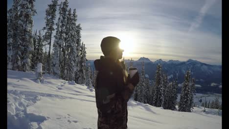 Woman-with-coffee-cup-standing-on-the-snow-covered-landscape-4k