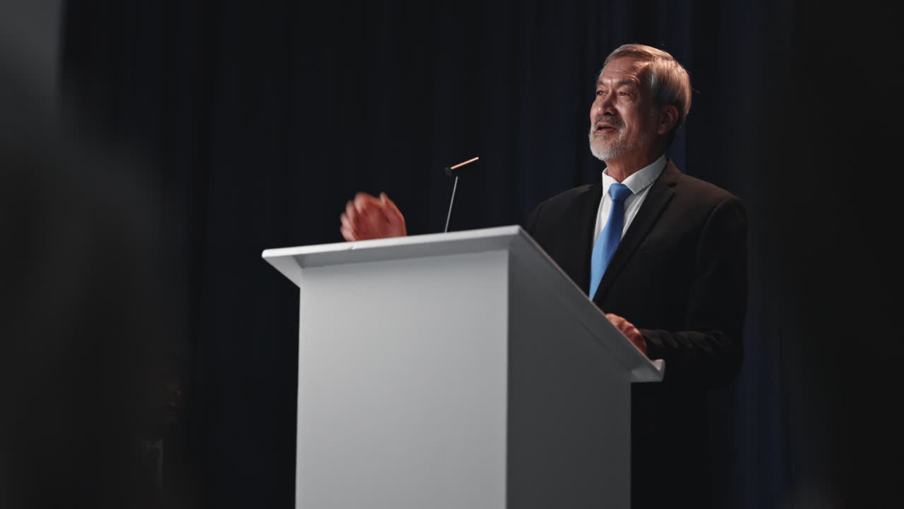Man giving a speech at a podium
