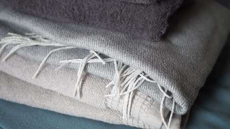 stack of gray and silver towels and blankets