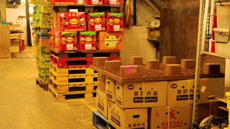 stacks of boxes and bustling market activity