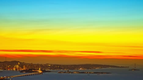 Lapso-De-Tiempo,-Puesta-De-Sol-Sobre-San-Francisco-Y-La-Bahía,-Nubes-Sobre-El-Horizonte-Del-Océano-Pacífico-Y-Luces