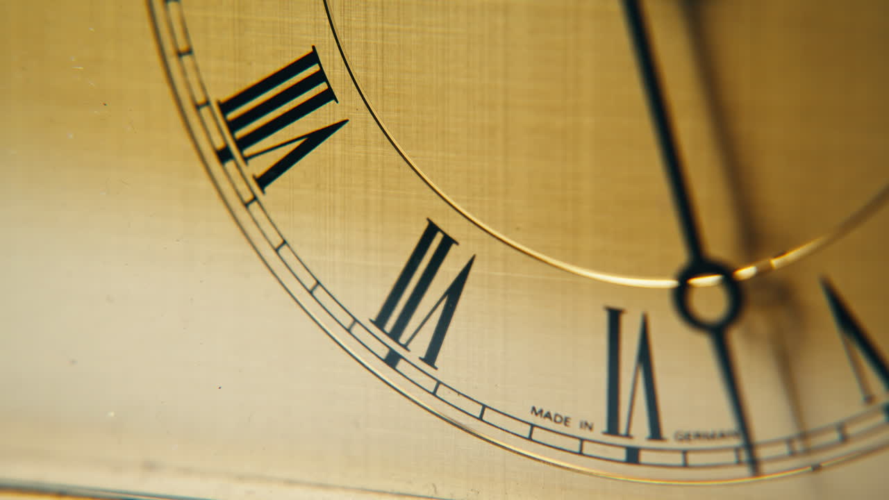Closeup classic clock ticking gently in daylight closeup. Arrow showing time