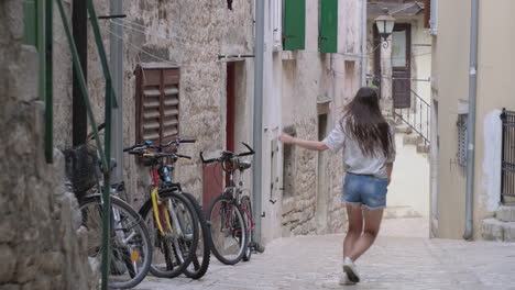 young woman running through an old european town