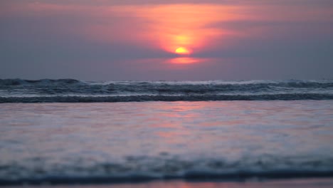 relaxing waves touching horizon at beach, purple sky, golden sun, colorful romantic summer sunset at beach, indian beach