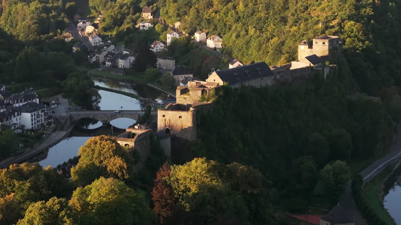 Picturesque castle nestled on a hilltop overlooking a charming town and river