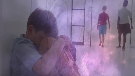 animation of smoke and lights over sad caucasian schoolboy sitting in school corridor