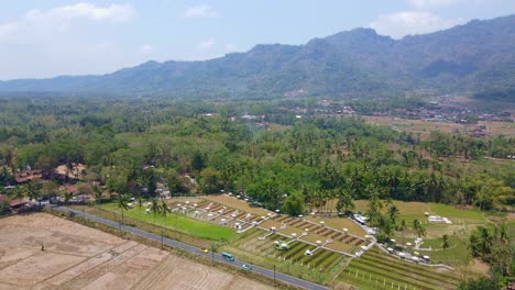 Aerial-view-of-"Svargabumi"-tourist-attraction-with-Menoreh-Hill-on-the-background