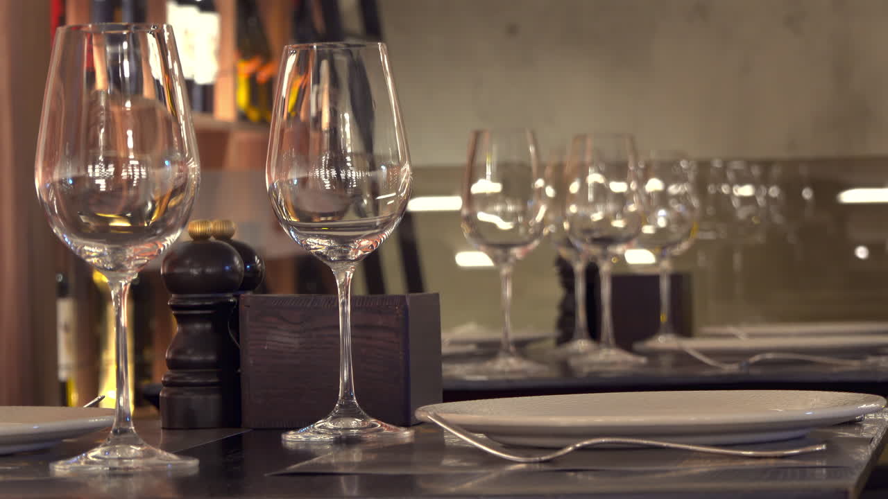 Close up of wine glasses on multiple set tables at a restaurant