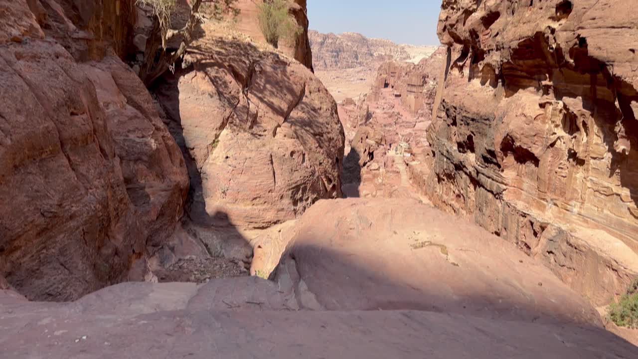 mirando entre los acantilados de piedra arenisca a través de un cañón en petra, jordania