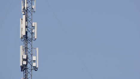 Telephoto-shot-of-5G-mobile-phone-mast-against-sky,-copy-space-right