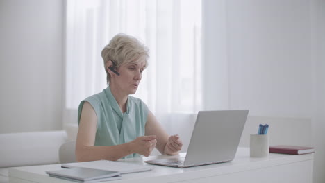 woman teacher is lecturing online by laptop with video calling e-education and examination learning distant