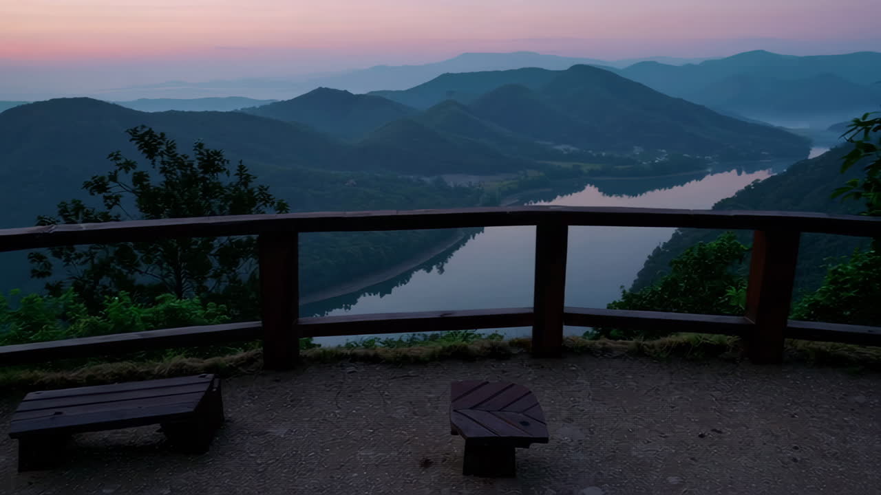 Sunrise over the mountains and lake from a viewpoint