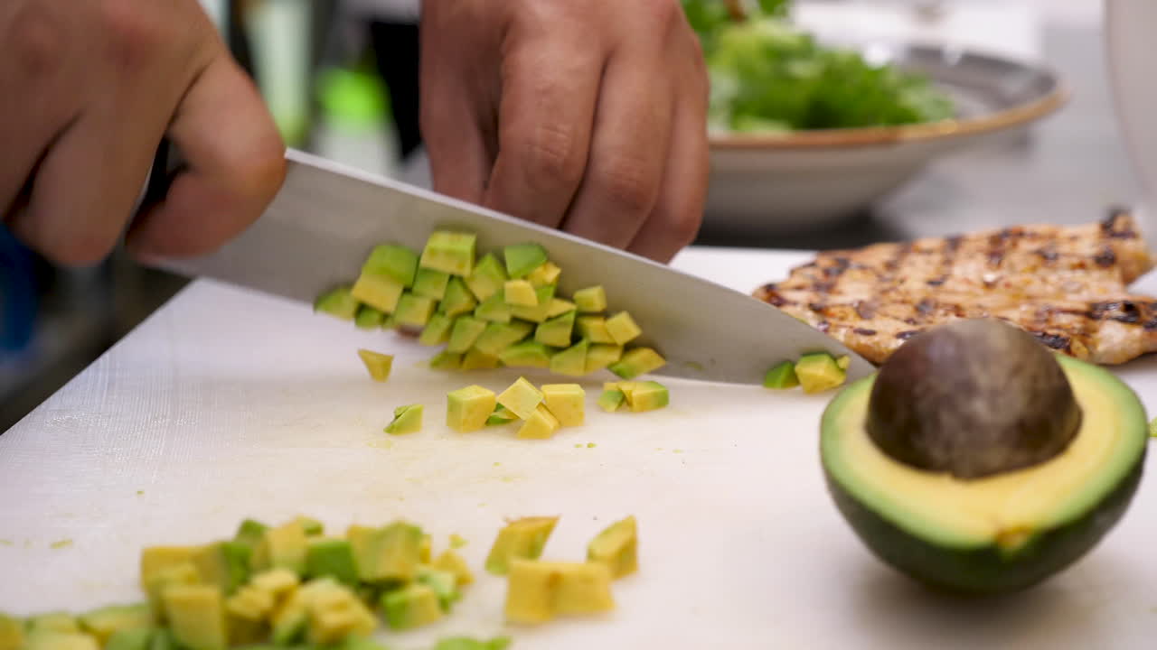 Preparing avocado, chicken and salad