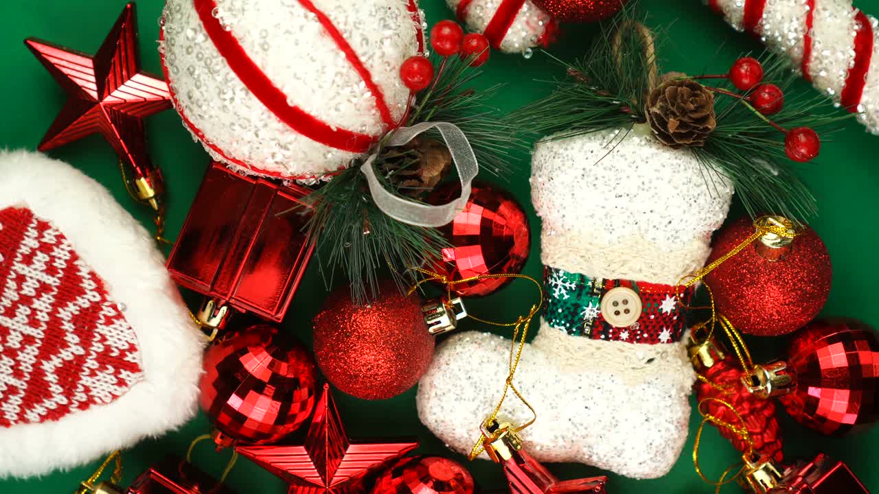 크리스마스 장난감은 초록색 배경에 밝은 빛으로 회전합니다. 새해 패턴.