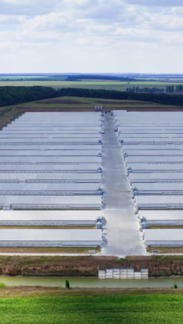 large modern farm in the countryside. rows of white farmhouses on field. agricultural complex on green landscape. aerial view. vertical video