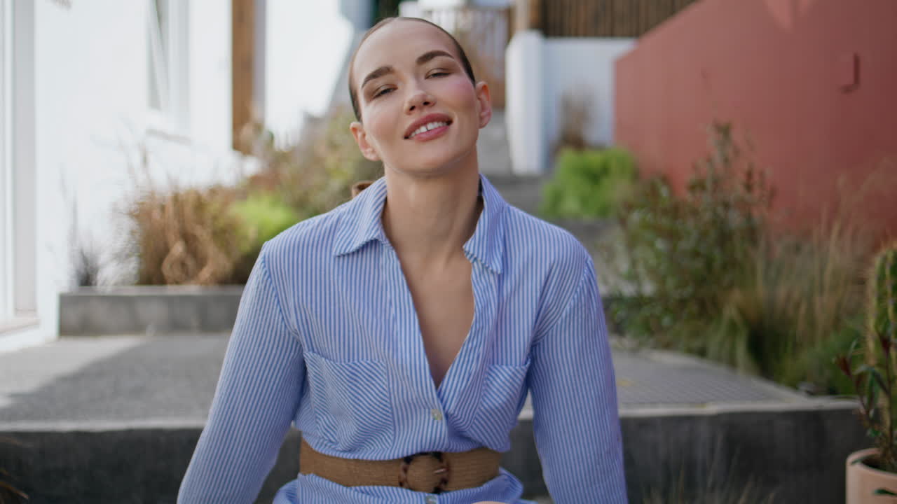Attractive woman posing stairs enjoy weekend in city closeup. Girl sitting patio