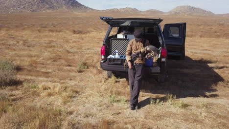 Young-Man-Falconer-Rests-on-Truck-Tailgate-with-His-Falcon-Hawk-Raptor