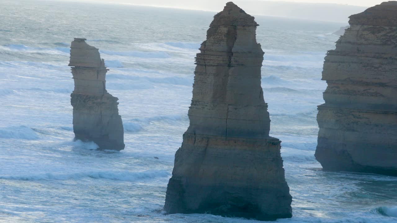 A serene view of the Twelve Apostles rock formations along the Great Ocean Road, captured in soft morning light