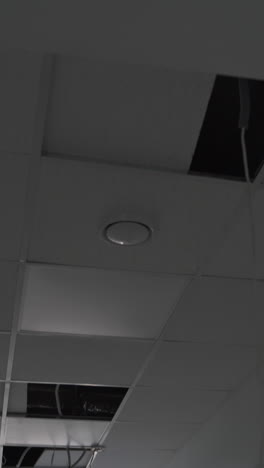 recently built premises with unfinished inside works. light system in the process of installation. wires hanging from the ceiling. vertical video