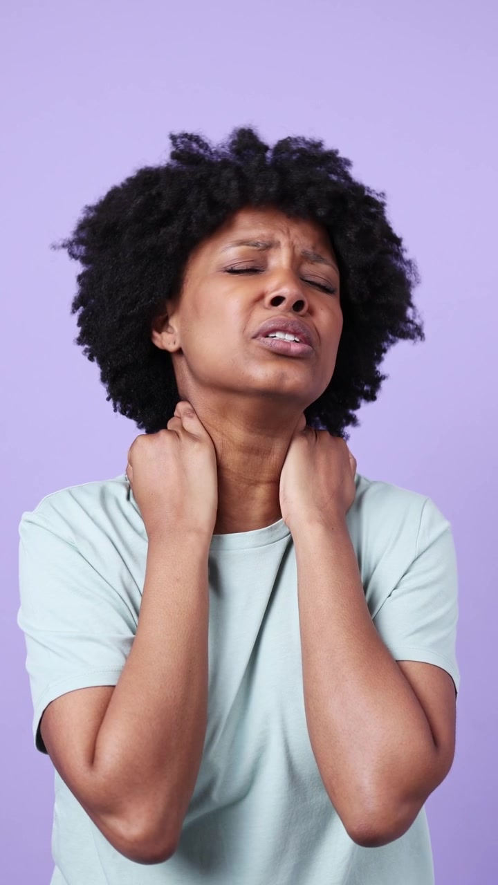 Giovane donna afroamericana che soffre di dolore e disagio al collo