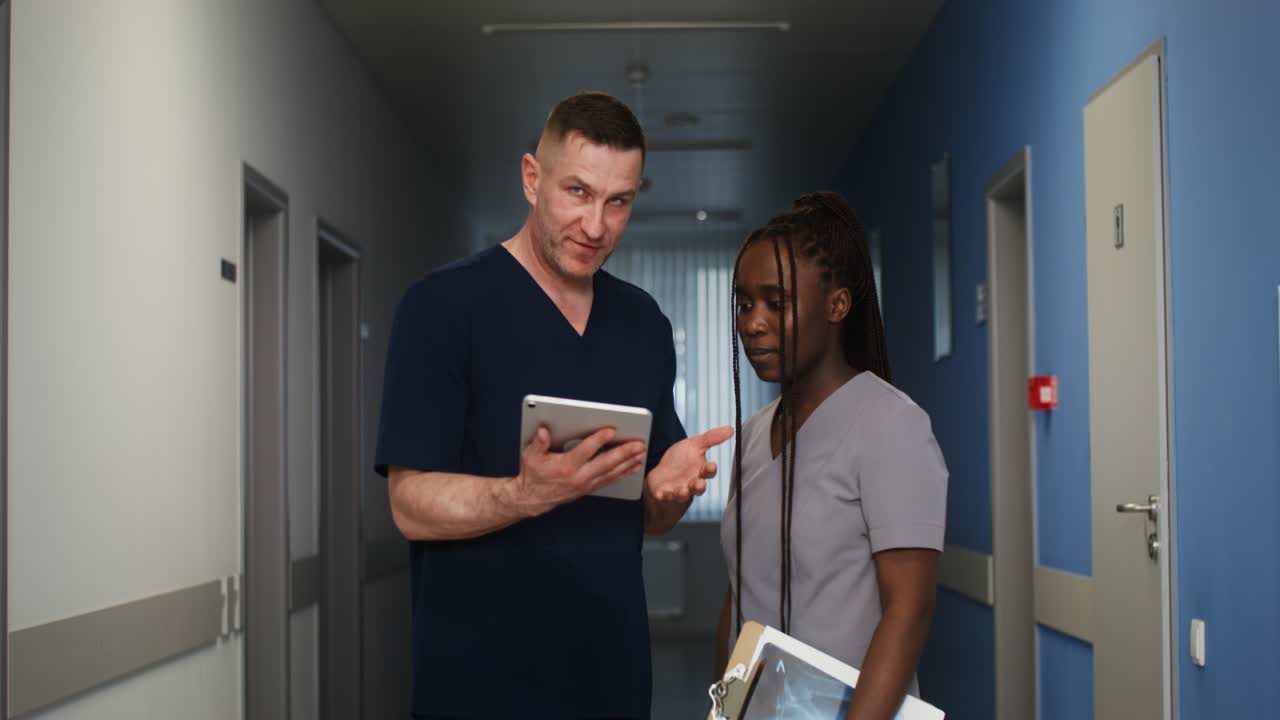Doctors and Nurses Discussing a Patient in a Hospital Corridor