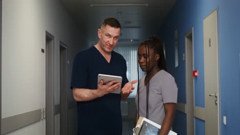 doctors and nurses discussing a patient in a hospital corridor