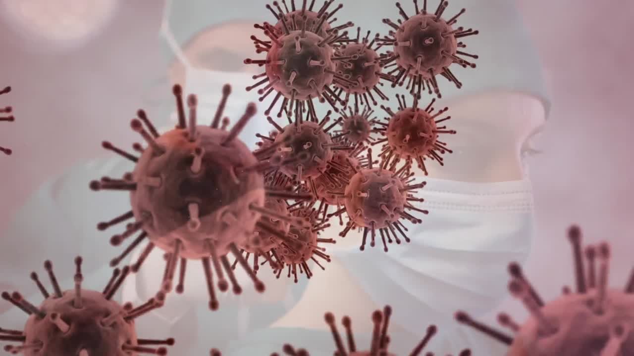 Animazione di cellule Covid-19 che fluttuano sopra chirurghi con mascherine