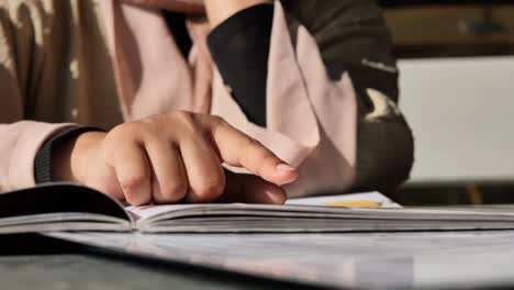 woman reading a book in a cafe