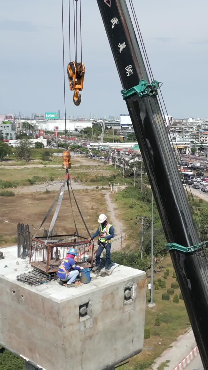 Construction of a bridge with a crane and construction workers