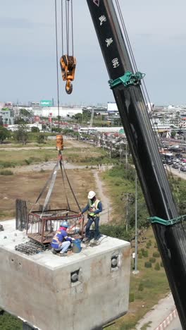 construction of a bridge with a crane and construction workers