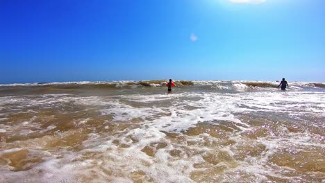 boy having fun in sea. excited child playing with sea waves