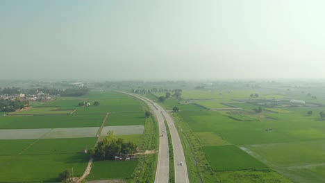 amazing aerial view of the well-organized agricultural land divided by the express highway in punjab province, india