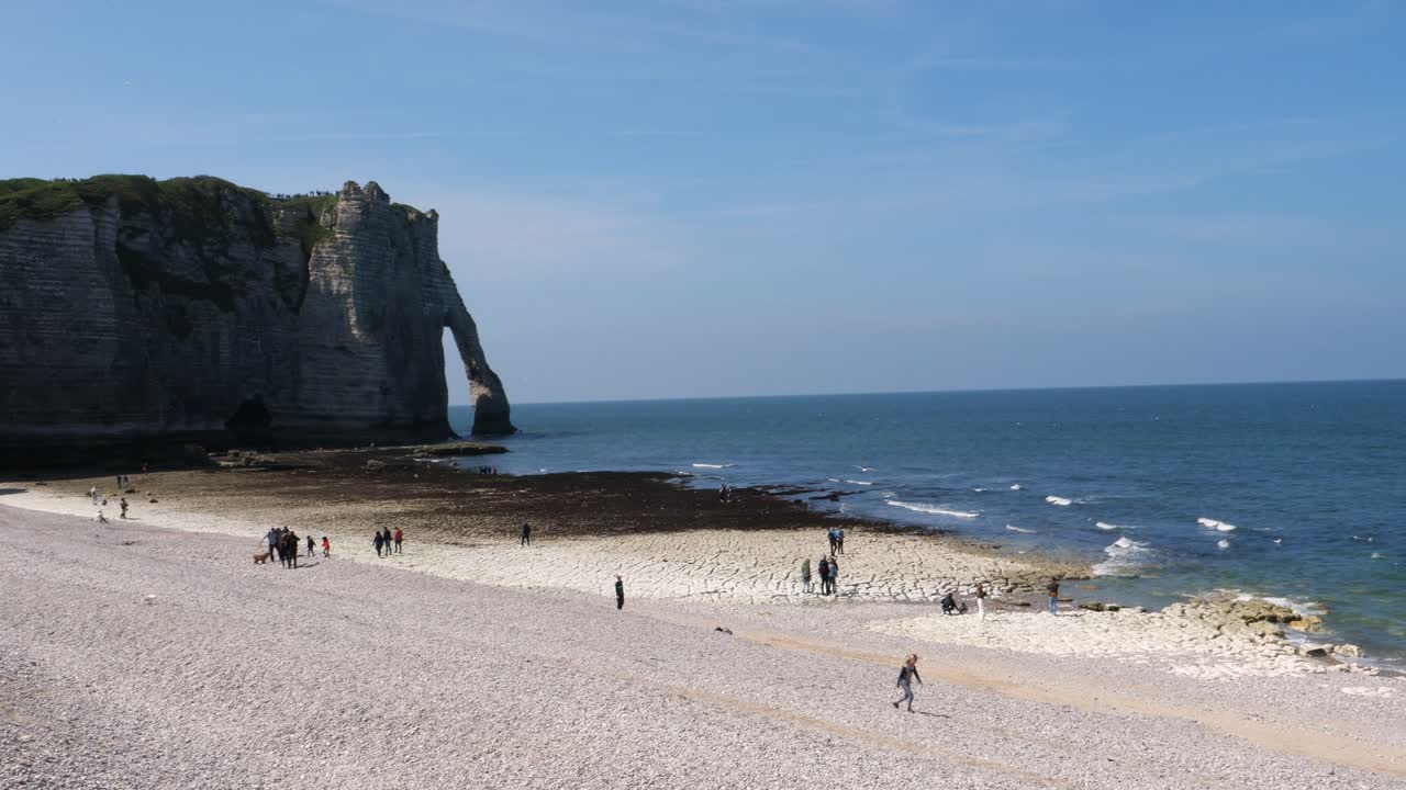 프랑스 에서  ⁇ 은 파란 하늘 을 가진 아름다운  ⁇ 빛 날 - 배경 에 유명한 바다 절벽 형성 을 가진 에트레타트 의 자갈 해변 에서  ⁇ 고 있는 사람 들 의  ⁇ 기 사진
