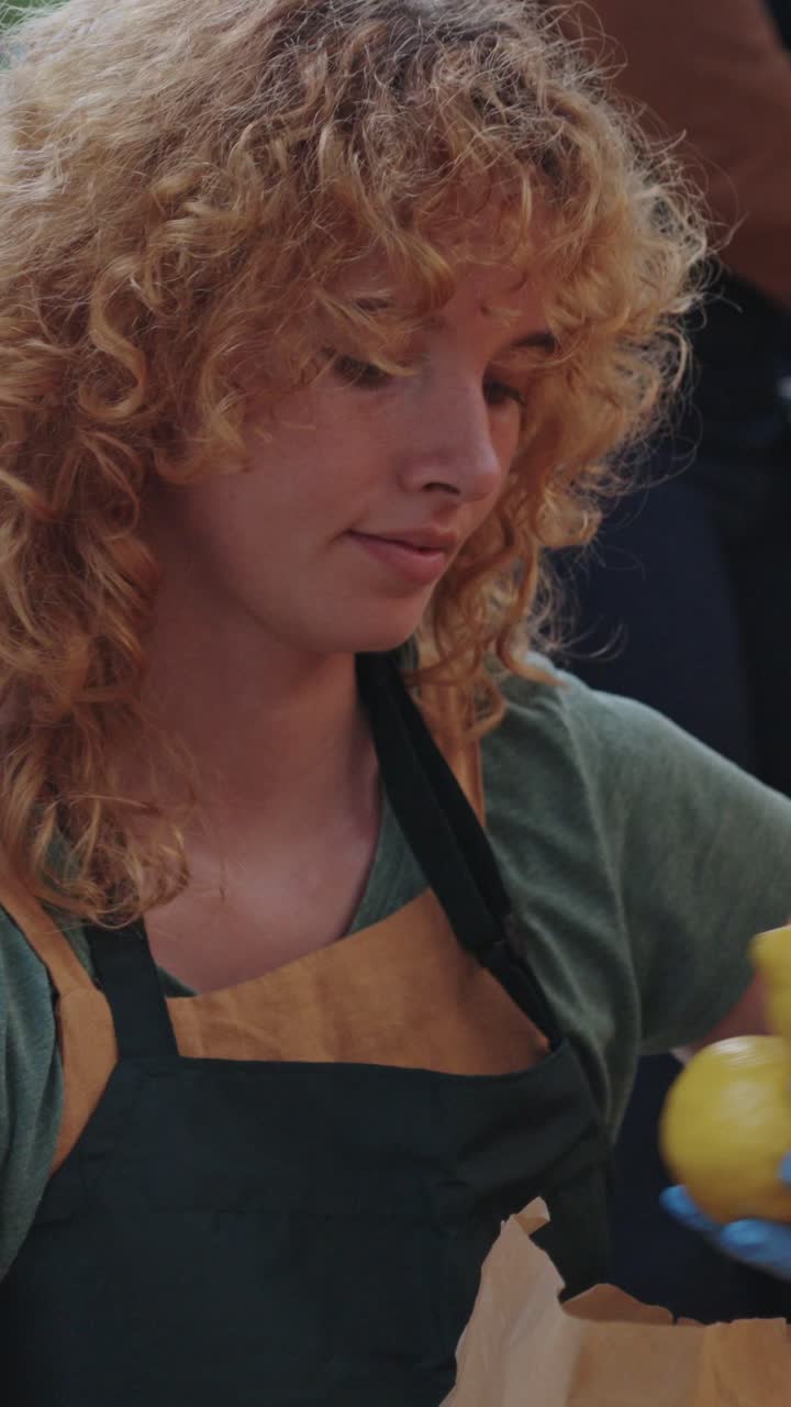 Woman with curly hair wearing an apron