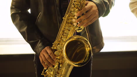 street jazz busker plays a saxophone in a band on the streets of toronto