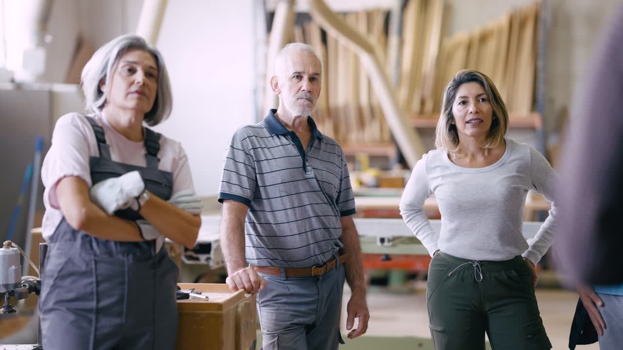 Diverse Team of Workers Listening Attentively in a Workshop