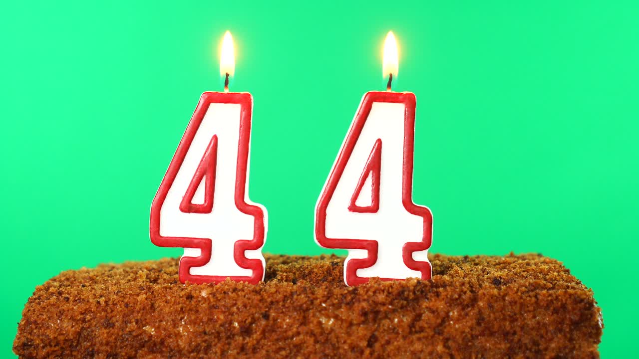 Cake with the number 44 lighted candle. Chroma key. Green Screen. Isolated