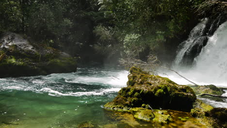 Panning-shot-of-crashing-waterfall-flowing-into-Tarawera-River-during-sunny-day-in-paradise-of-New-Zealand