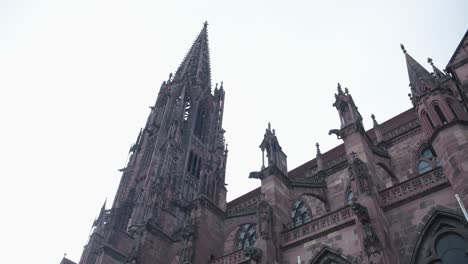 view of the tower of freiburg cathedral on a cloudy day