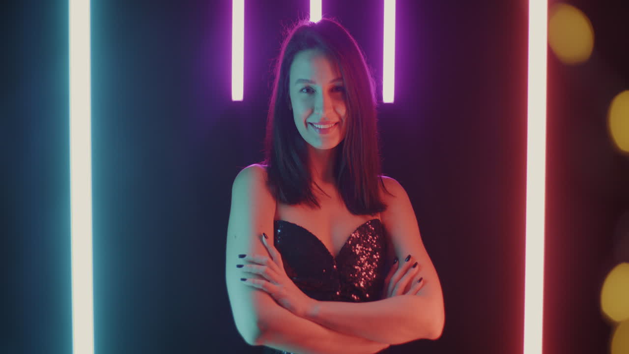 Woman in a black sequin dress with neon lights