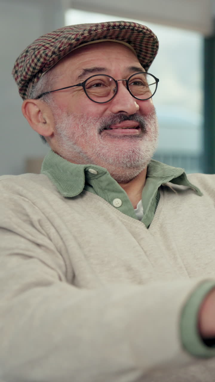 Close-up of Smiling Elderly Man with Glasses and Cap