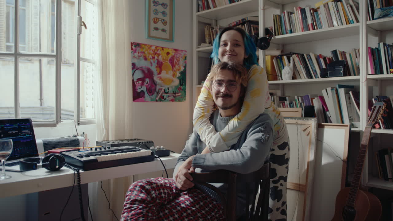 Young Couple Hugging and Posing for Camera at Home Recording Studio