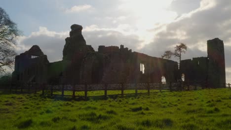 sun shines on bective abbey backlit light outlines old monastic settlement walls in ireland