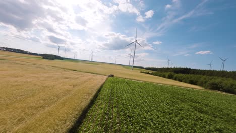 wind turbines on a sunny day, fpv aerial view