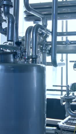 modern milk factory with stainless tubes. steel huge diary factory technologies. vertical video