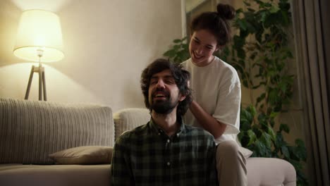 Woman-massaging-head-of-her-man-in-living-room-at-home