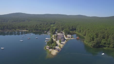 aerial view of a lake resort with boats and buildings