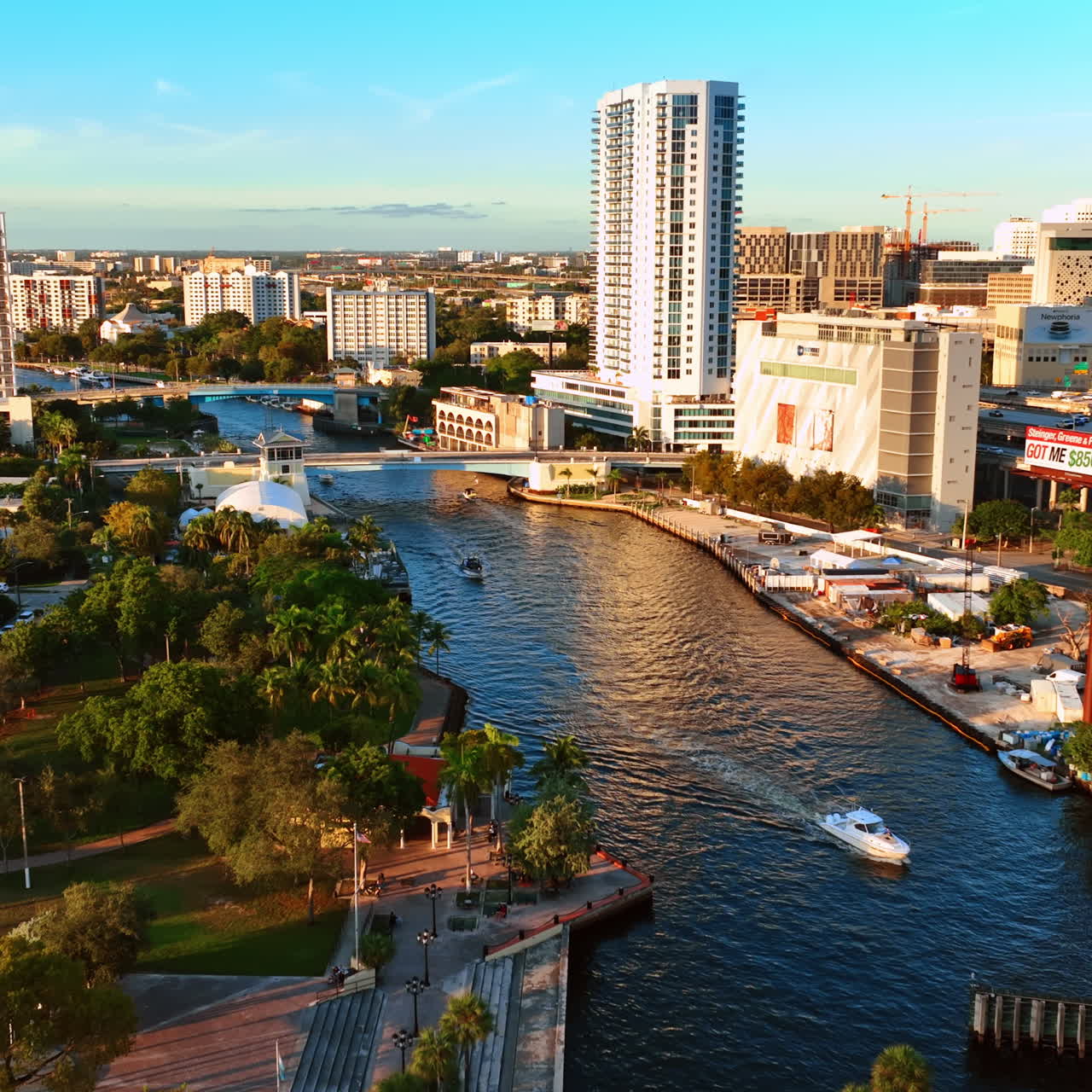 Motor boats are on the narrow river in the city downtown. Beautiful view of sunny Miami panorama, Florida, USA.