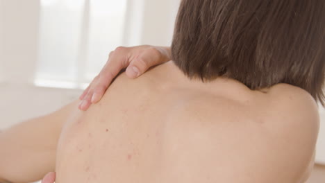 back view of contemporary male japanese dancer who is training dance moves with her hands in the studio